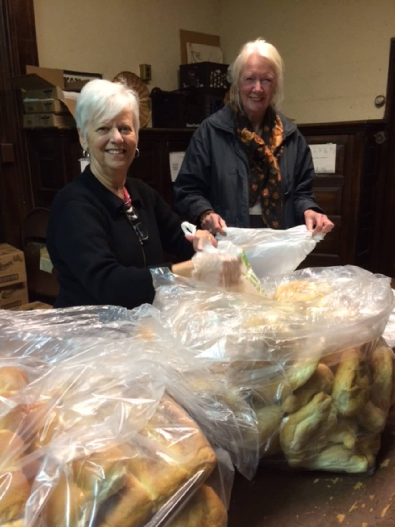 Christina Cafarelli and Karin Chaudhari from Ossining Food Pantry with bags of bread donated by the Ossining Bakery