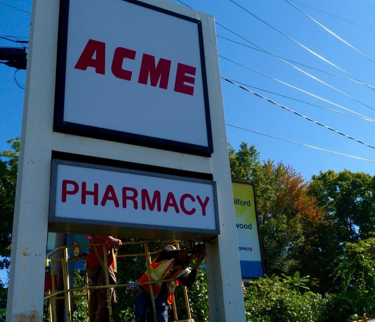 Workers in Bergenfield changing the signage from Pathmark to ACME. The new grocery store opens on Wednesday, Oct. 14. 