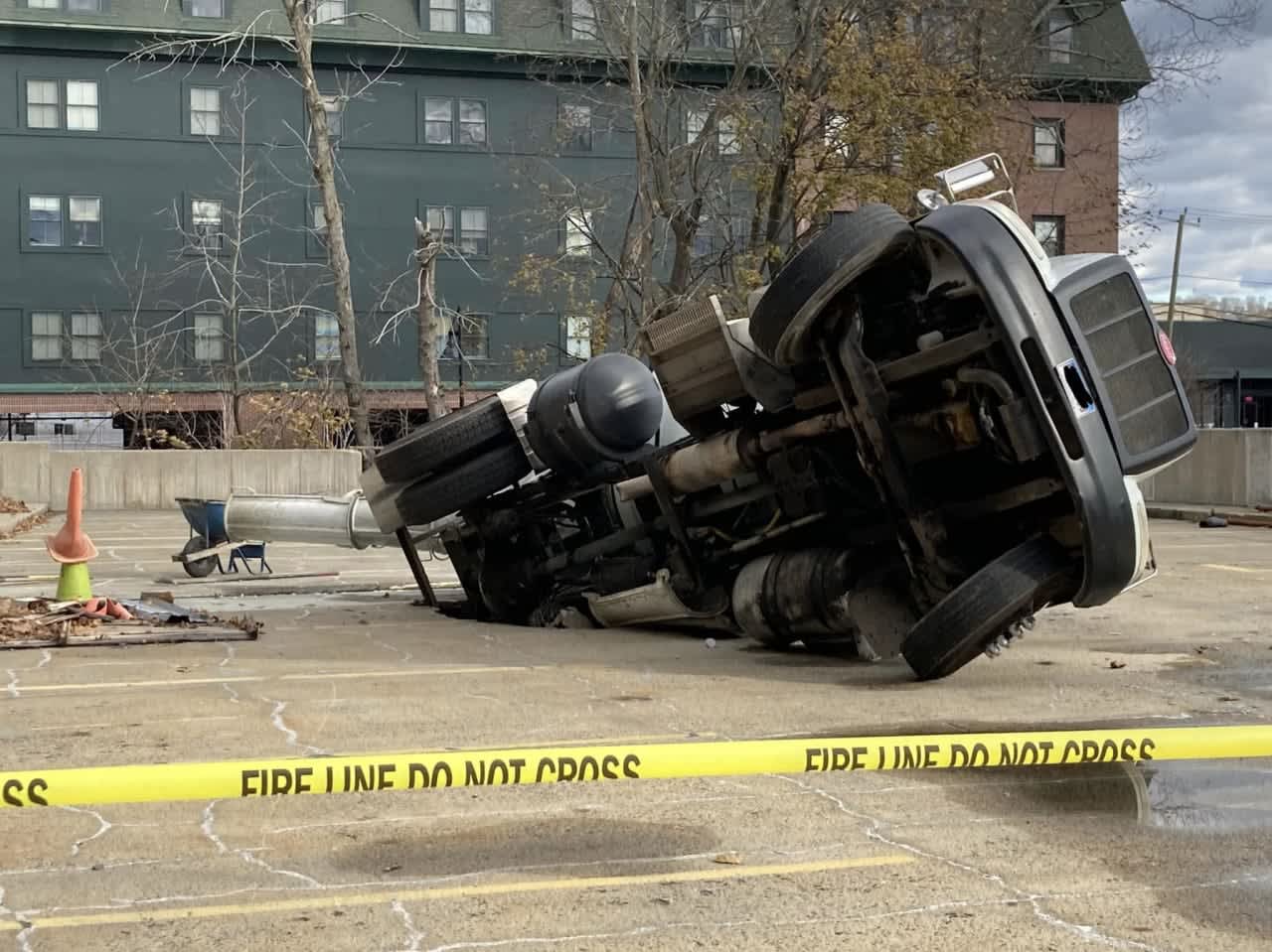A cement truck driver was injured when his truck fell through a parking lot in Fairfield County.