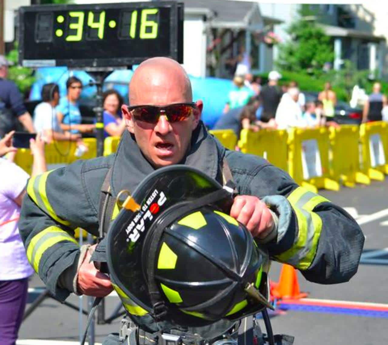 A New Milford firefighter crosses the finish line at a previous 5K Run.