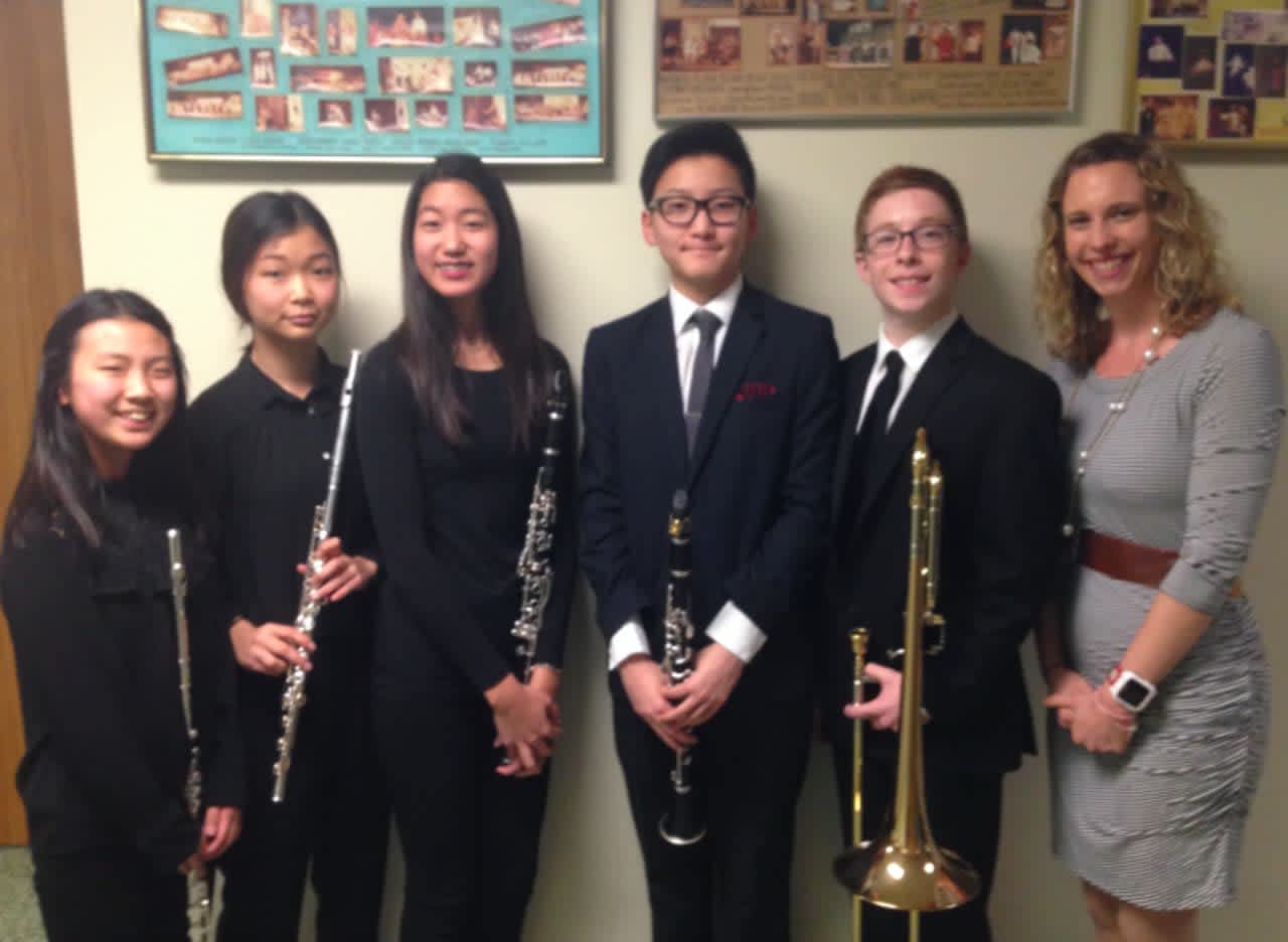 From left: Minhee Han, Jeannie Jeon, Kayla Yi, Austin Yang, Charles Hall and band director Amy Wilcox