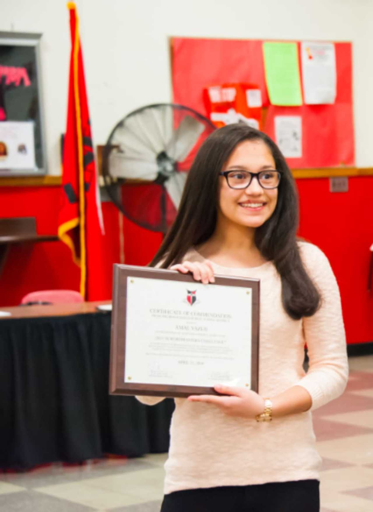 Amal Yazej receives her certificate of commendation from the Bergenfield Board of Education.