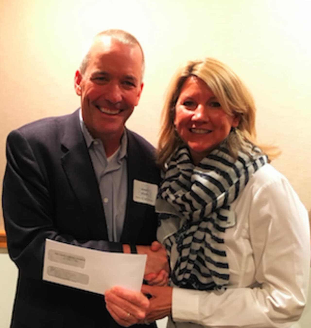 Jim Bosek, Shelter for the Homeless board chair, with New Canaan Community Foundation board member Kay Linneman after receiving a $12,500 grant to support the shelter’s emergency meals program.