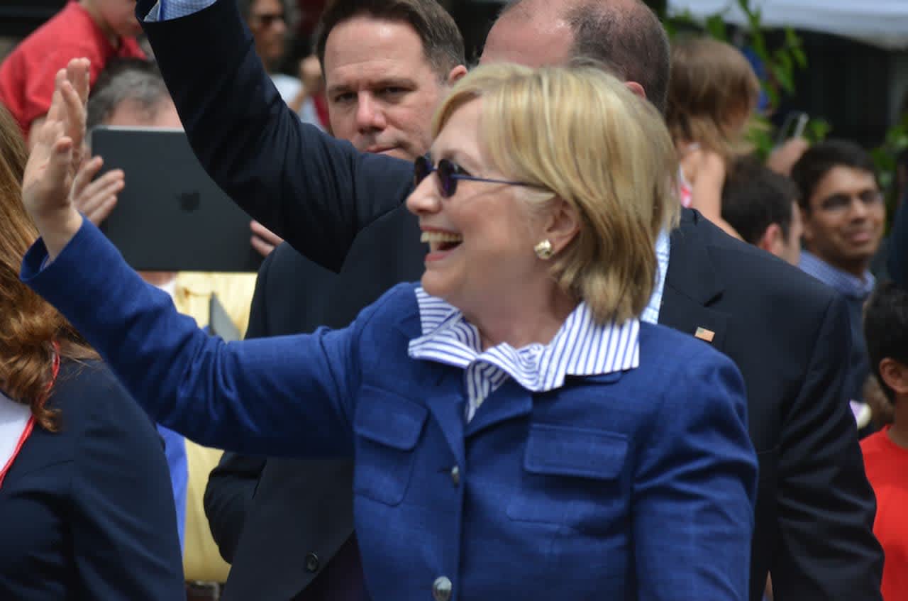Hillary Clinton waves as she marches in the town of New Castle's 2016 Memorial Day parade, which went through downtown Chappaqua on Sunday.