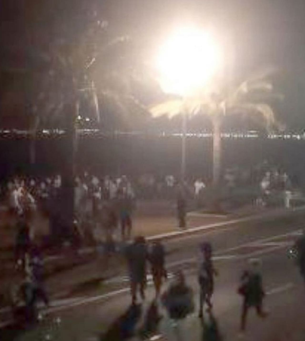 Bastille Day revelers in Nice, France run for cover after a truck rammed through the crowd Wednesday.