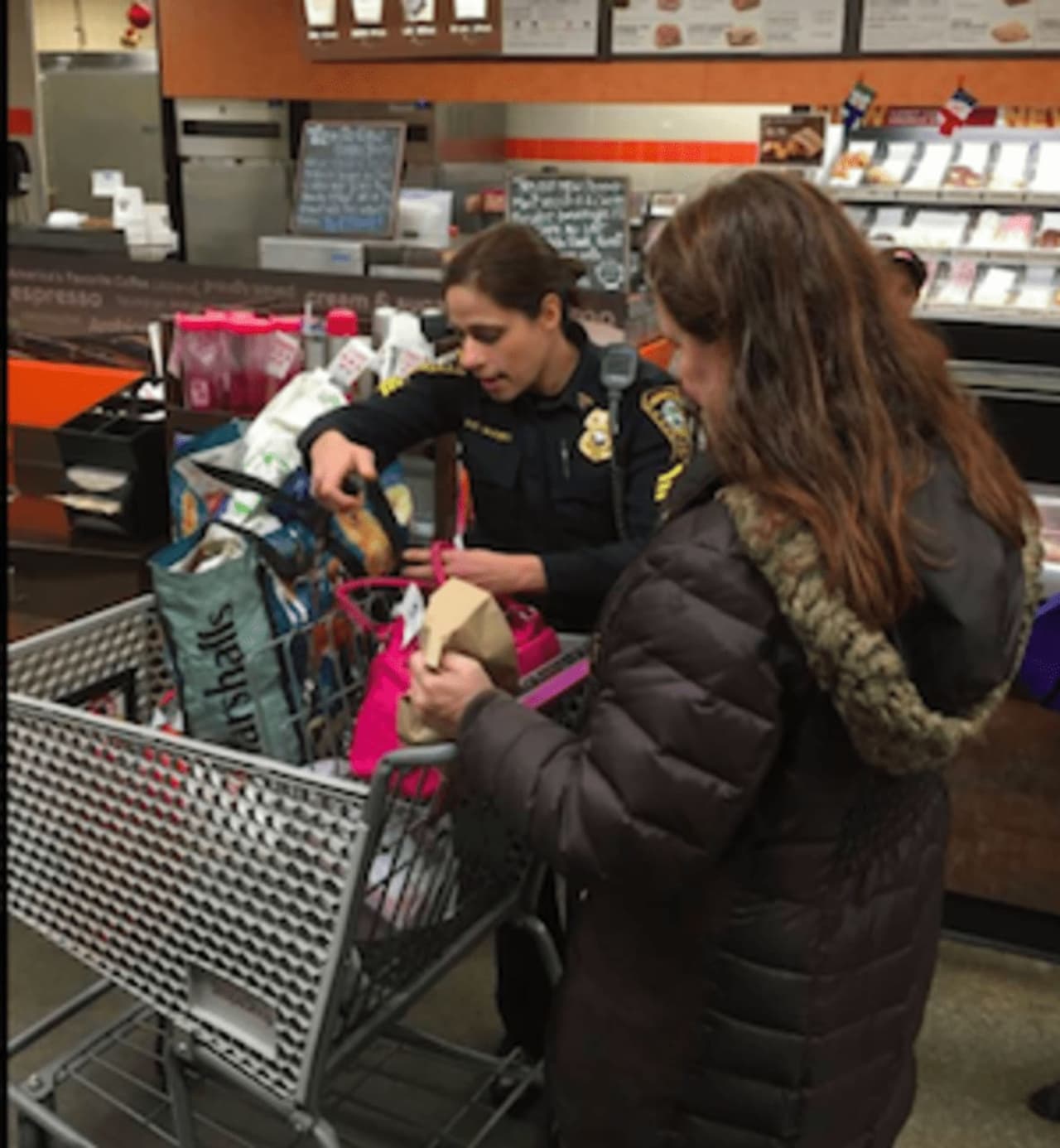 Sgt. Sofia Gulino checks with a customer on how to protect valuables from theft while shopping.