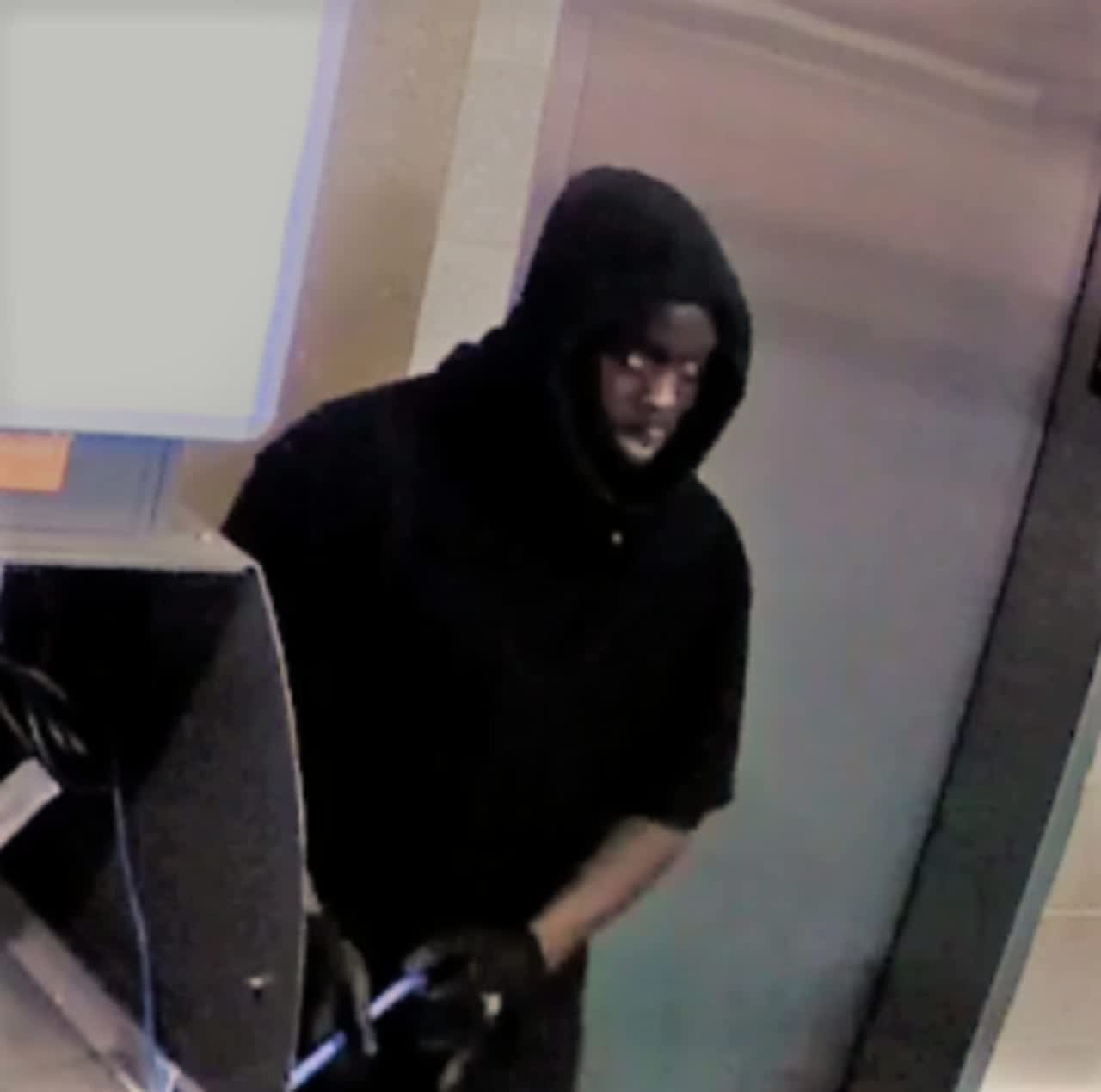 An African American suspect was caught on camera allegedly robbing parking machines and an ATM in Norwalk.