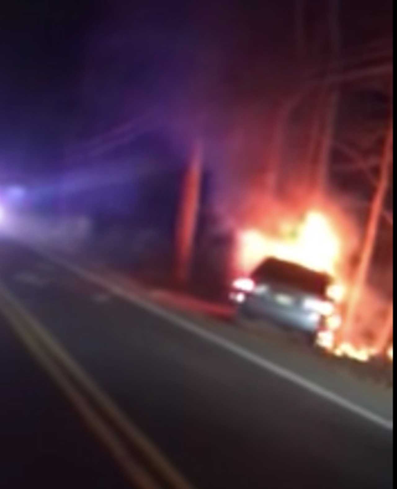 A Howell police officer rescued a driver from this fiery crash.