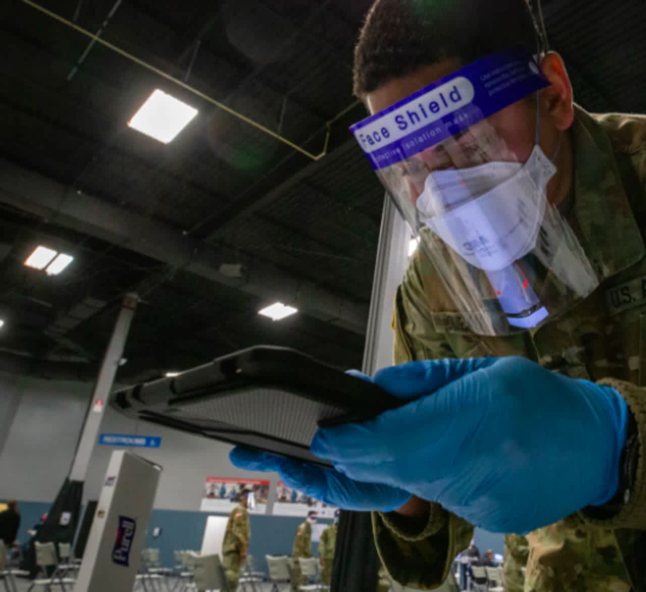 A U.S. Army Soldier with the 44th Infantry Brigade Combat Team, New Jersey Army National Guard, scans the driver’s license of an individual who received the COVID-19 vaccine.