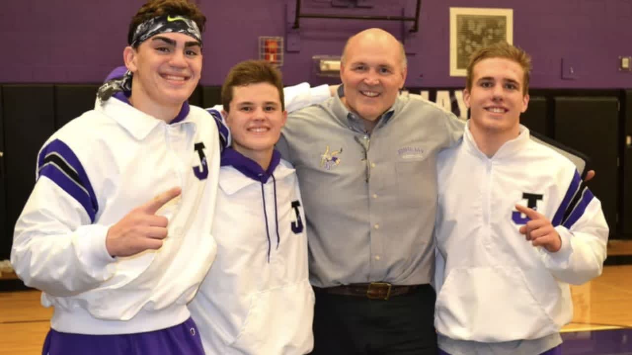 Wrestling coach Bill Swertfager pictured with students.