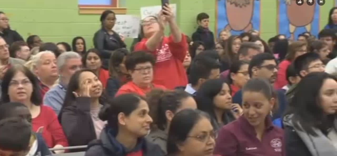 Several dozen people attended the Jersey City school board meeting Monday night to protest proposed staff cuts.