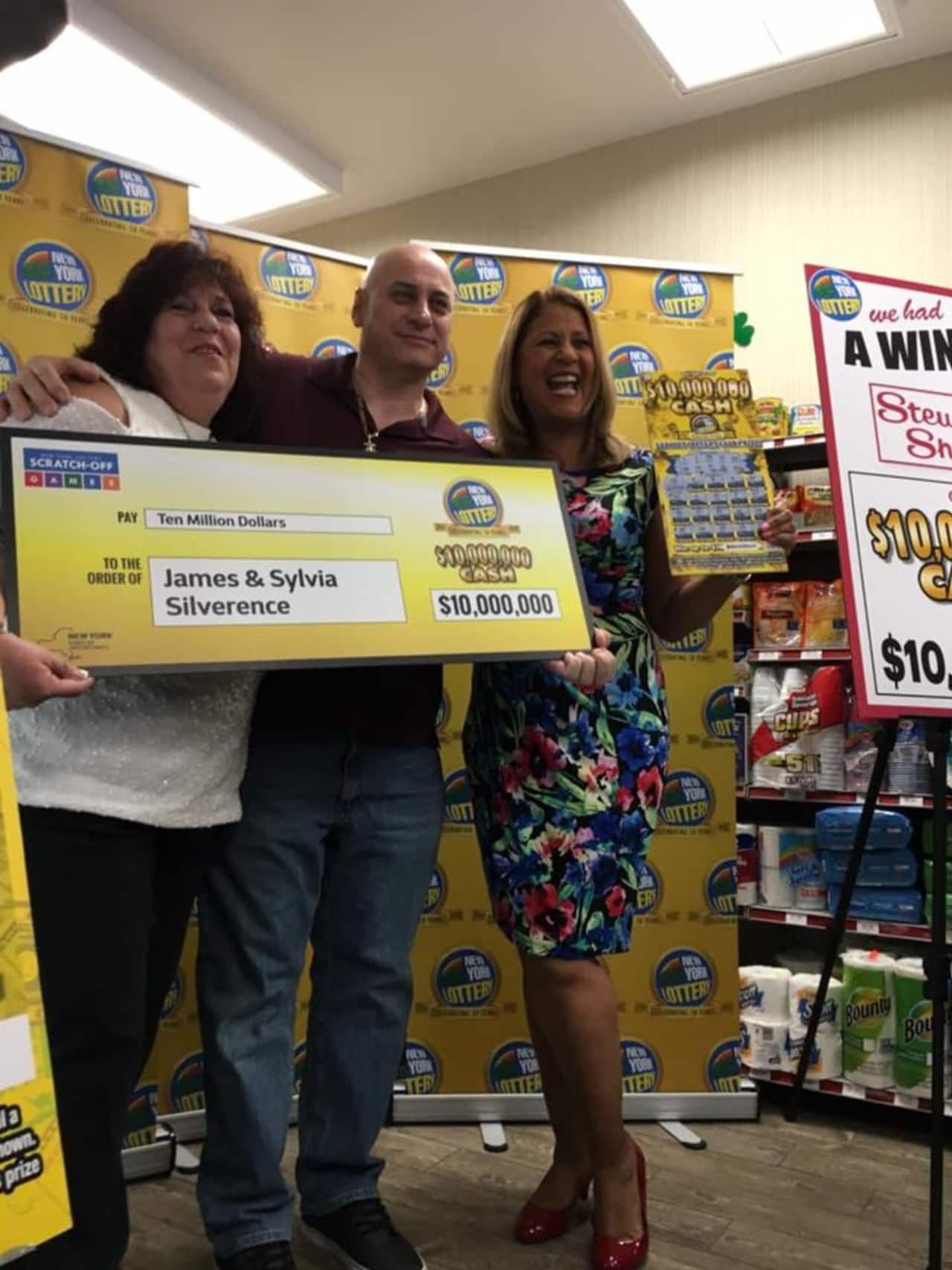 Poughkeepsie couple James and Sylvia Silverence accept an oversized check for $10 million from Lottery spokeswoman Yolanda Vega at a Stewart's Shops store Thursday.