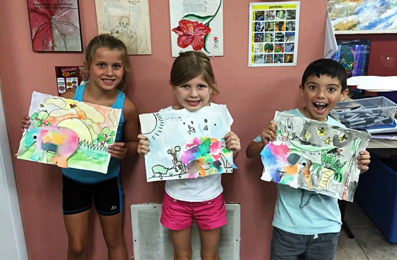 Students from the studio's summer camp show off their art.