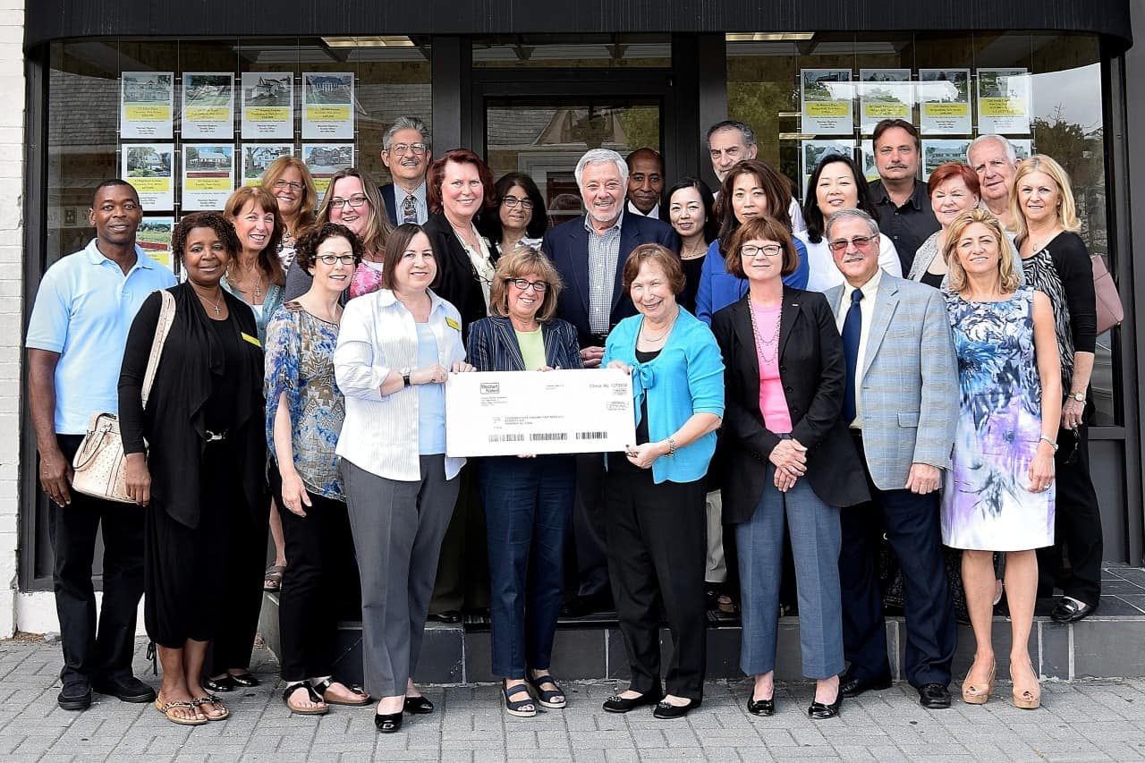 Judith Giordano, manager of the Weichert Realtors' Tenafly office, present Cynthia Massarsky, president of Make-It-Home, with a check to support Bergen County’s United Way Very Special Homes initiative.