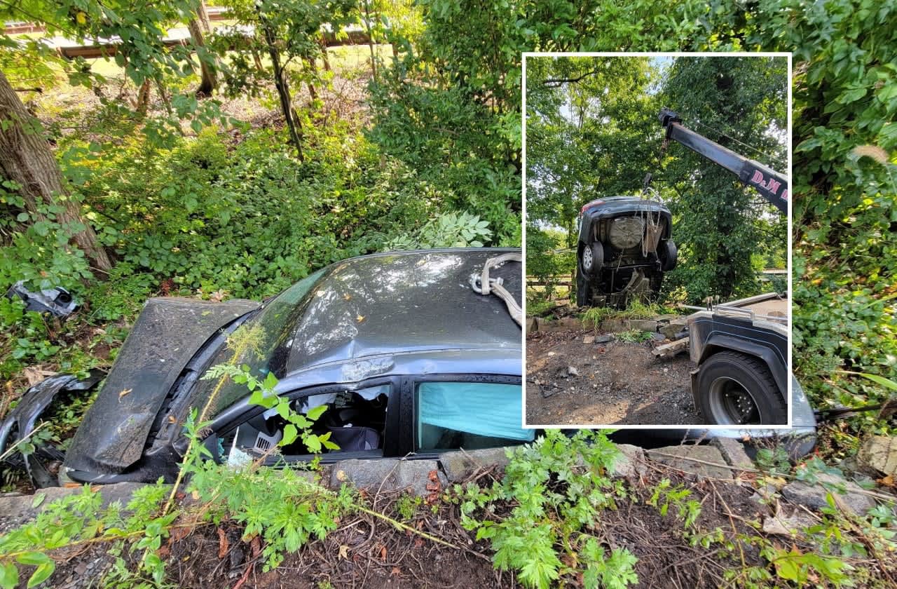 The sedan landed between Route 9W and the Palisades Interstate Parkway in Tenafly.