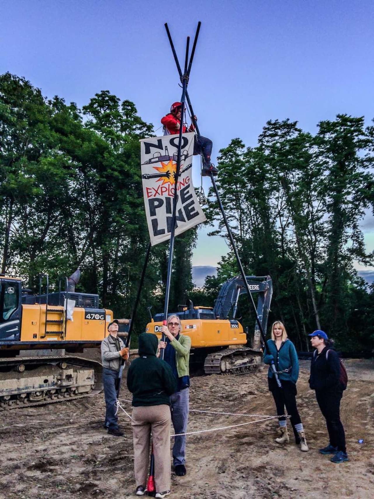 A protester climbed up a 20-foot tripod to oppose construction of the Spectra pipeline.