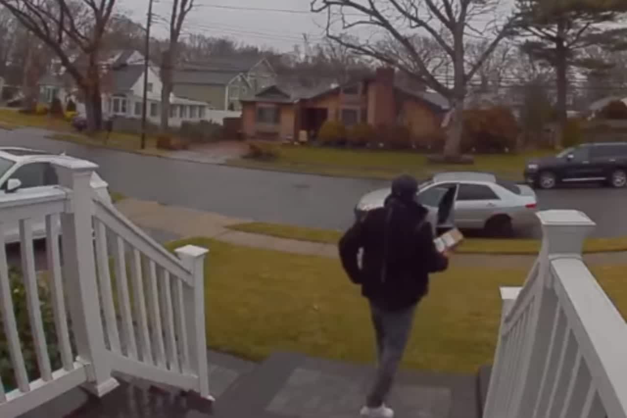 Nassau County Police are investigating after a man was caught on surveillance video stealing a package from a front porch on Grant Street in Massapequa Park Thursday, Jan. 19.