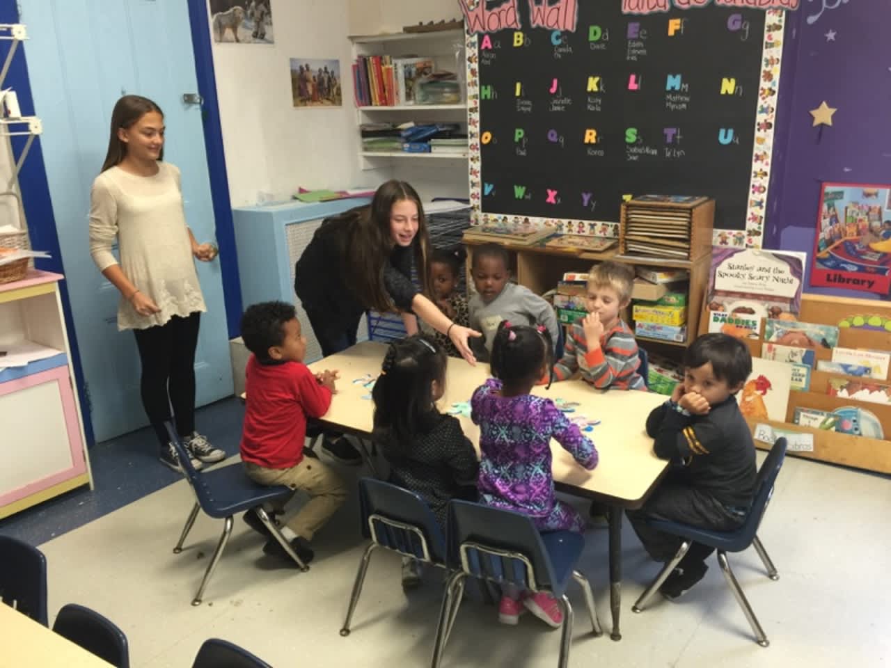 Seventh-grade Spanish and French classes are volunteering at the Ossining Children’s Center once a month, where they are reading stories in the languages they are studying to the preschool children.