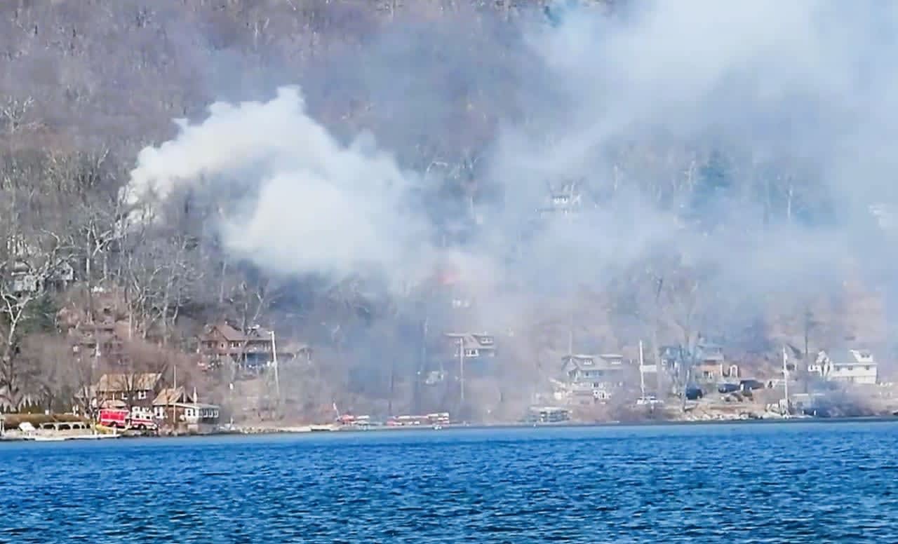 What began as a brush fire on Saturday, March 18, spread to three homes, and injured multiple firefighters, on a hill in West Milford overlooking Greenwood Lake.