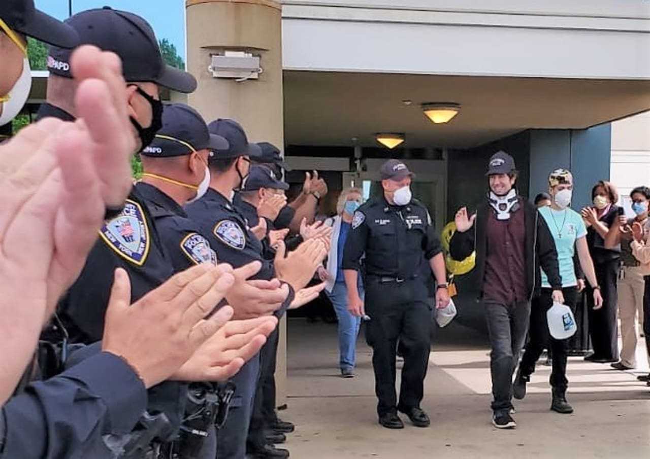 PAPD Officer Peter Siano applauded as he lefts the Kessler Institute for Rehabilitation.