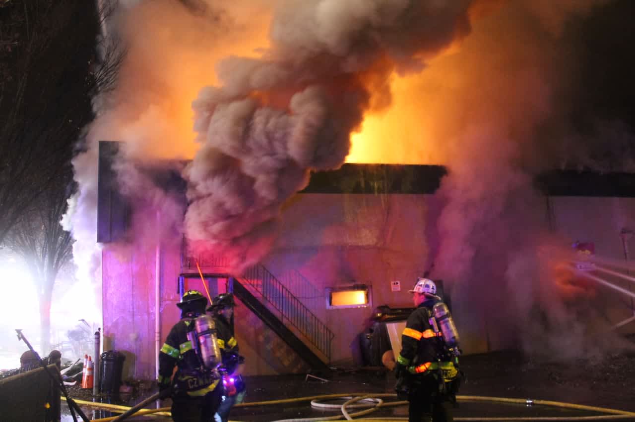 Flames shot through the roof of the uniform supply store on Main Street in Lodi.