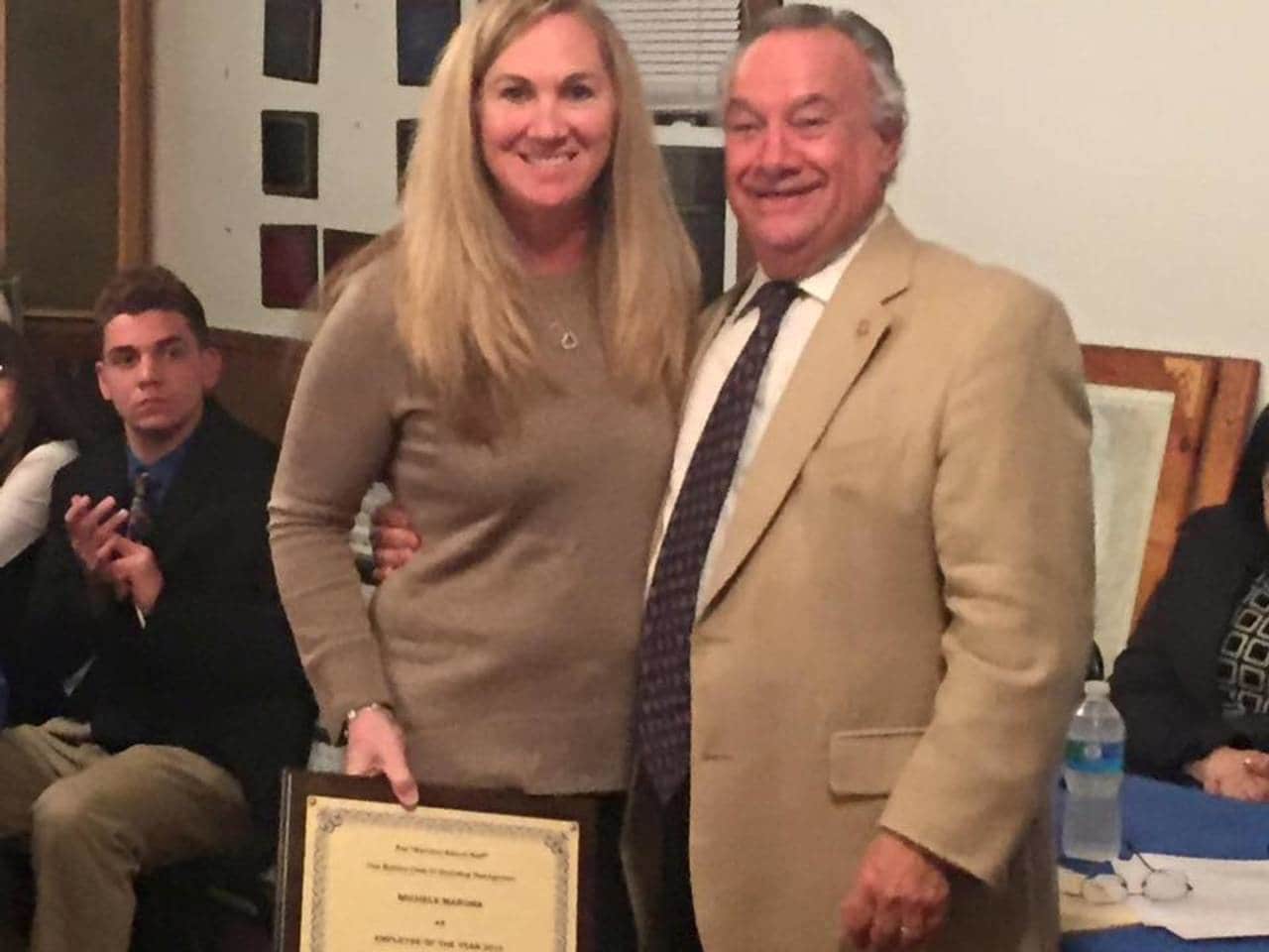 Michele Marona, senior office assistant in the Guidance Department at Ossning HighSchool, and George Weeks of the Rotary Club.