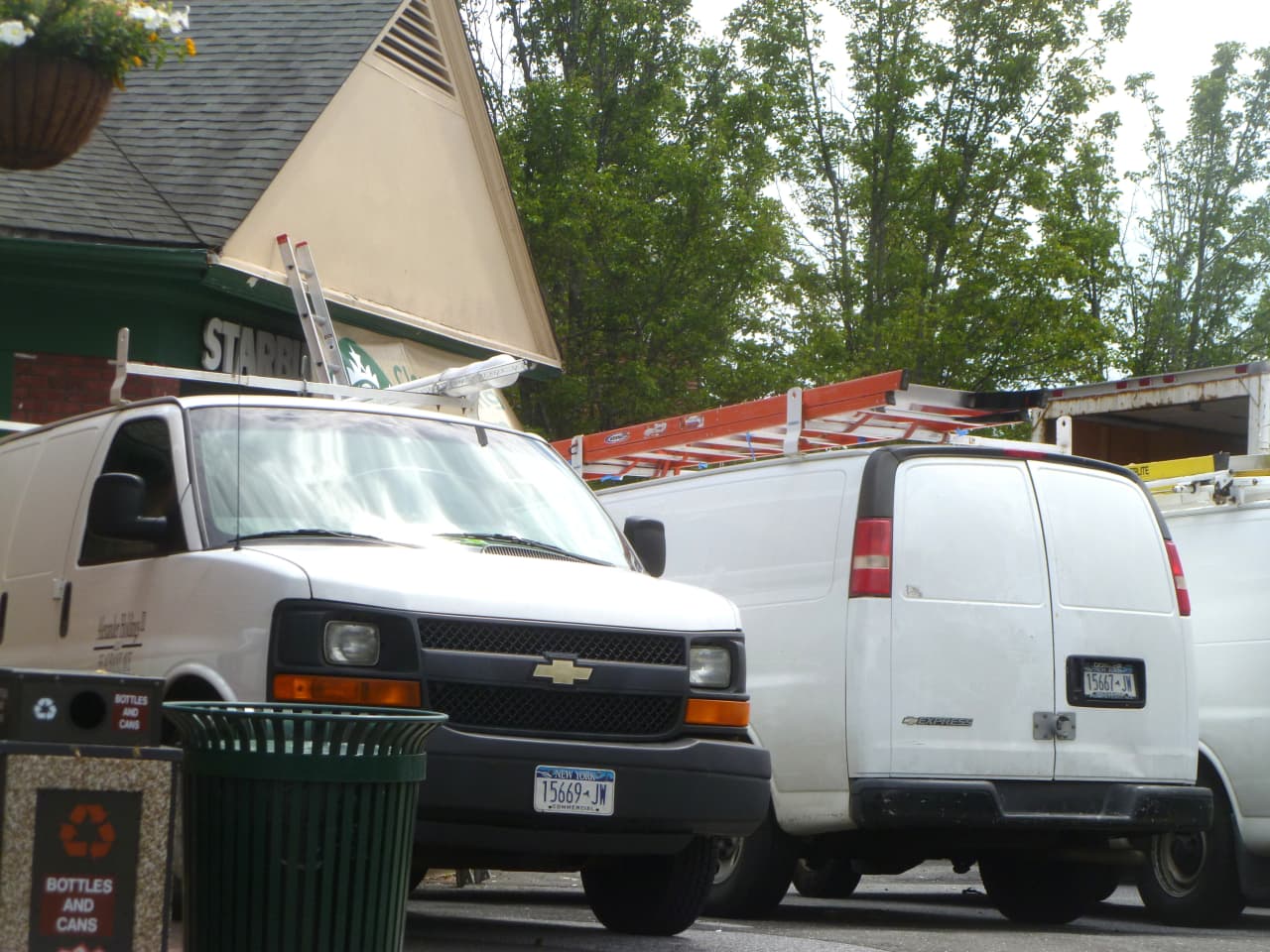 Six white trucks were parked outside of the New Canaan Starbucks where renovations are under way. 