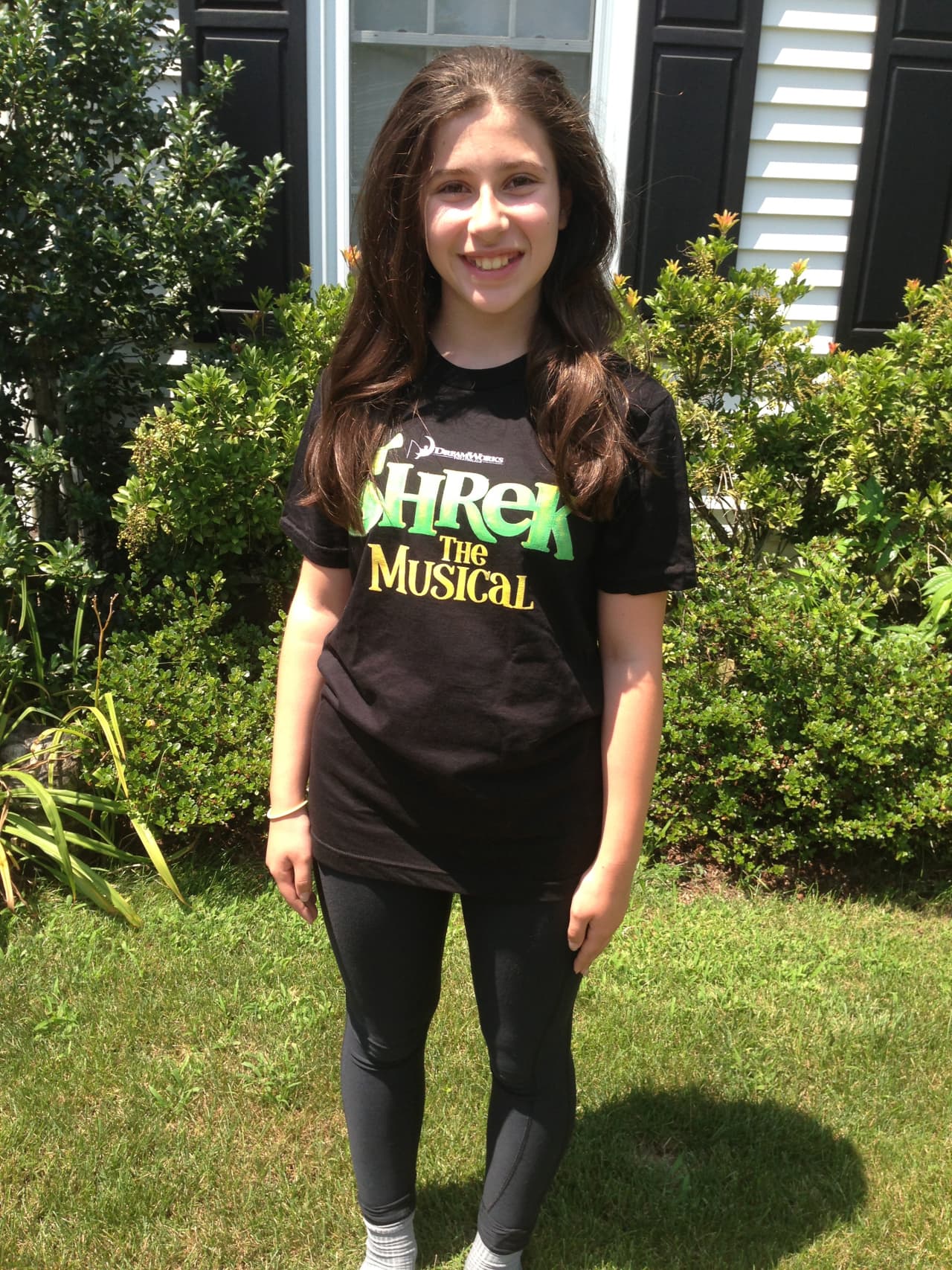 Isabella Salant of New Canaan wears her "Shrek The Musical" t-shirt, a production she will be acting in along with two others from town. 