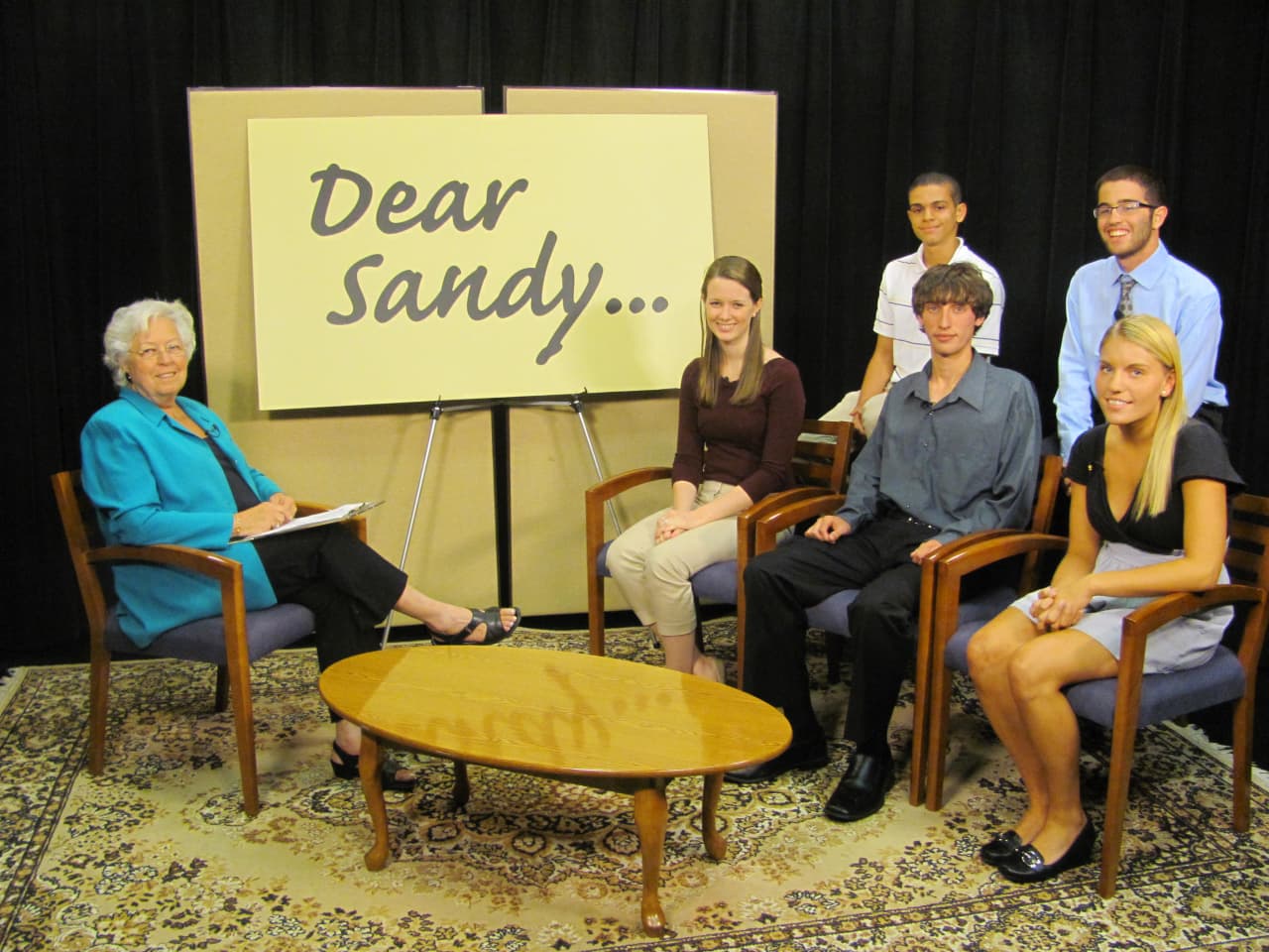 Assemblywoman Sandy Galef (far left) with five of her recent interns, Jeffrey Guzman (back left), Ross Beroff (back right), Alanna Powers (front left), Brendan Zarkower (front center) and Cat Purdy (front right) on the set of Dear Sandy.