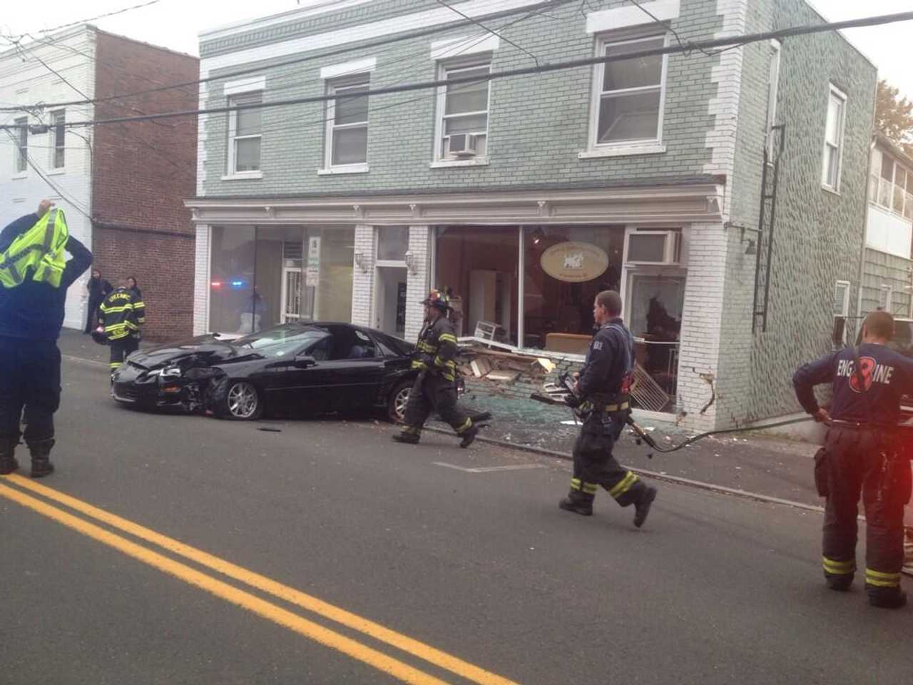Greenwich firefighters respond after a Camaro slammed into a business on Pemberwick Road. 