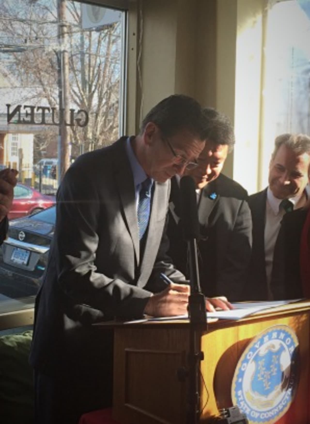 Gov. Dannel Malloy signs the GMO labeling law in Fairfield's Catch A Healthy Habit Cafe with local lawmakers and supporters. 