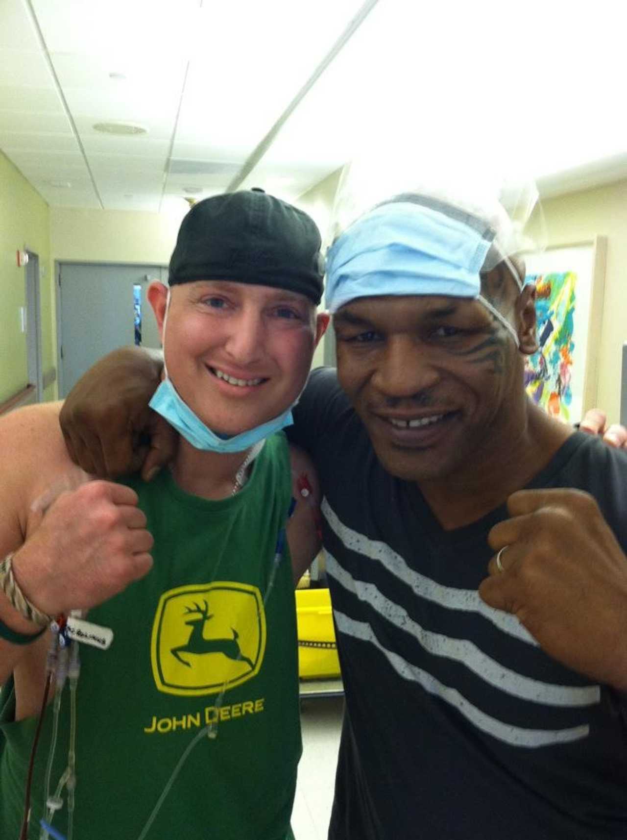 Jason Needle, two-time cancer survivor, poses with former boxer Mike Tyson. 
