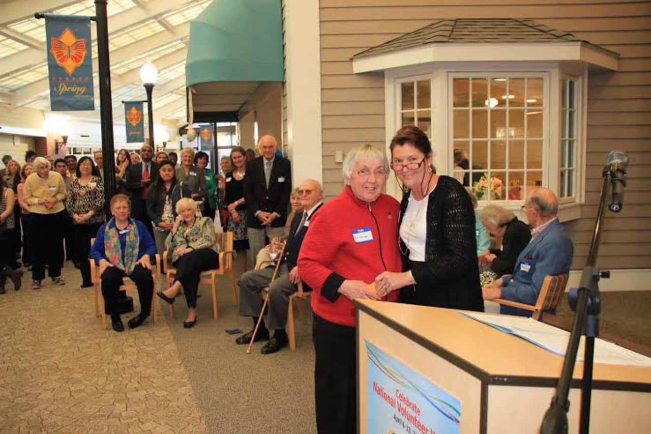 Long-time Waveny volunteer Fiz Tomaselli is presented with an award for her 3,700 volunteer hours of service. 