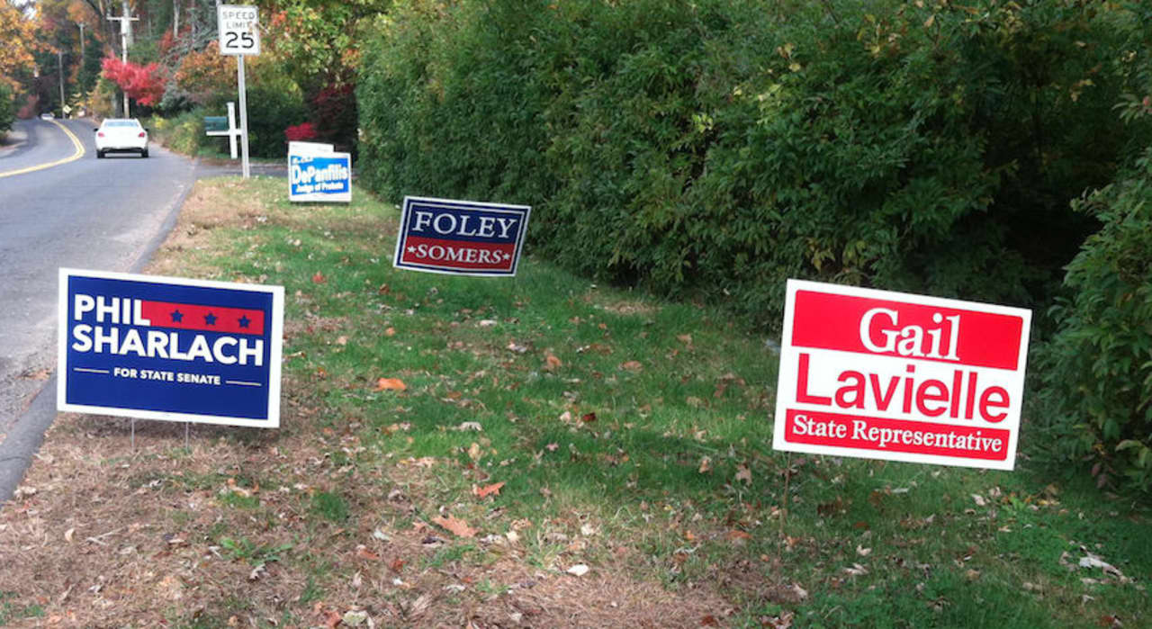Wilton votes today in an election in which the governorship is up for grabs in a close election between Gov. Dannel P. Malloy and his Republican challenger Tom Foley. Pictured are election signs in Wilton.