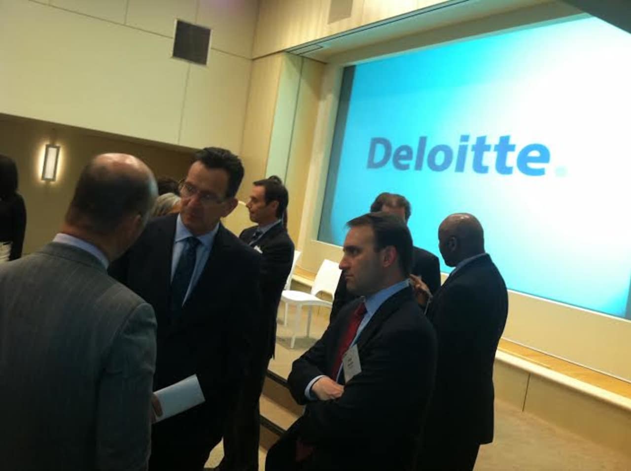Gov. Dannel Malloy speaks with Deloitte Managing Partner Steve Gallucci, at left, and Director Peter Brown, at right, during grand opening of Deloitte's new Stamford headquarters Tuesday.