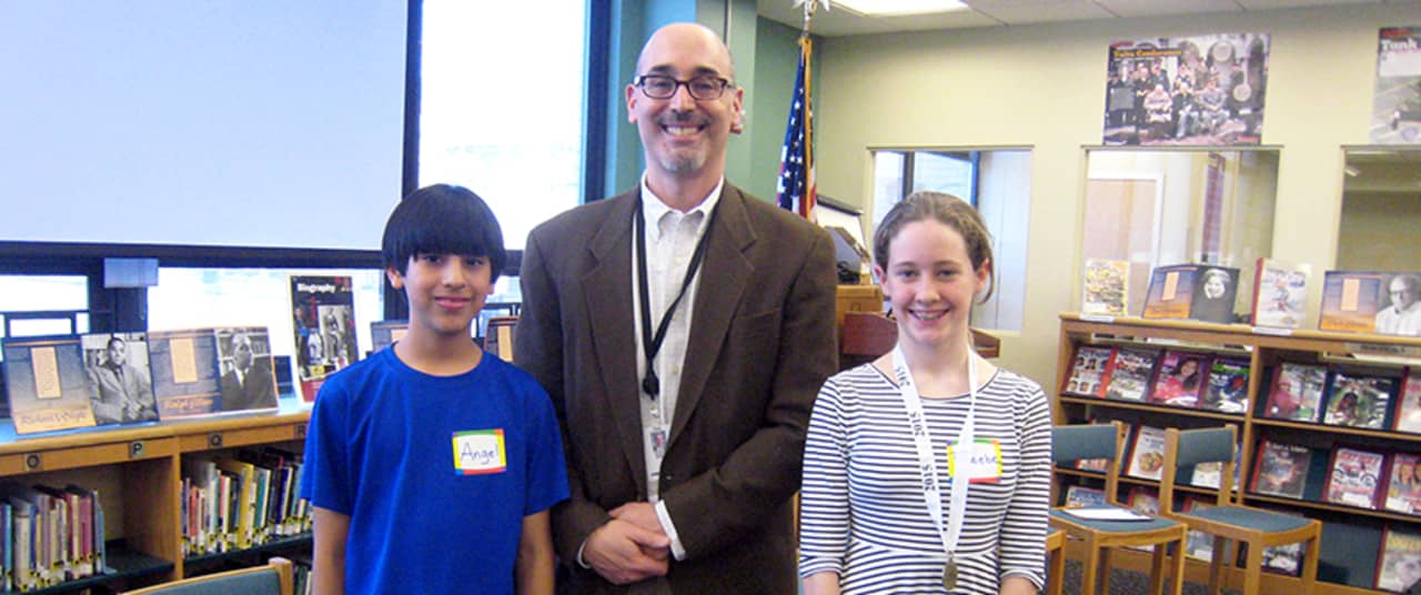 Phoebe Streeter and Angel Chavez-Ferreira, the final two Louis M. Klein finalists of the Geography Bee with Principal Scott Fried.