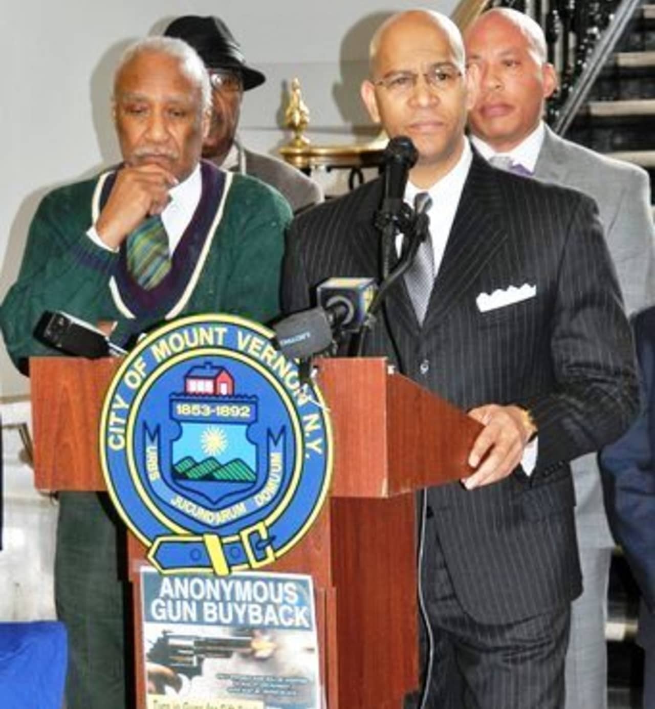 Mount Vernon Mayor Ernie Davis; Westchester County Crime Stoppers Chair Derickson K. Lawrence and Police Commissioner Terrance Raynor announcing the anonymous gun buyback. 
