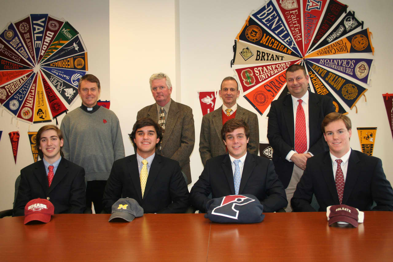 Fairfield Prep lacrosse players (front, left to right) James Marusi, Andrew Hatton, Kevin Brown and Strecker Backe recently made their college choices. They are show with (back, from left) Rev. John Hanwell, coach Chris Smalkais and AD Steve Donahue.