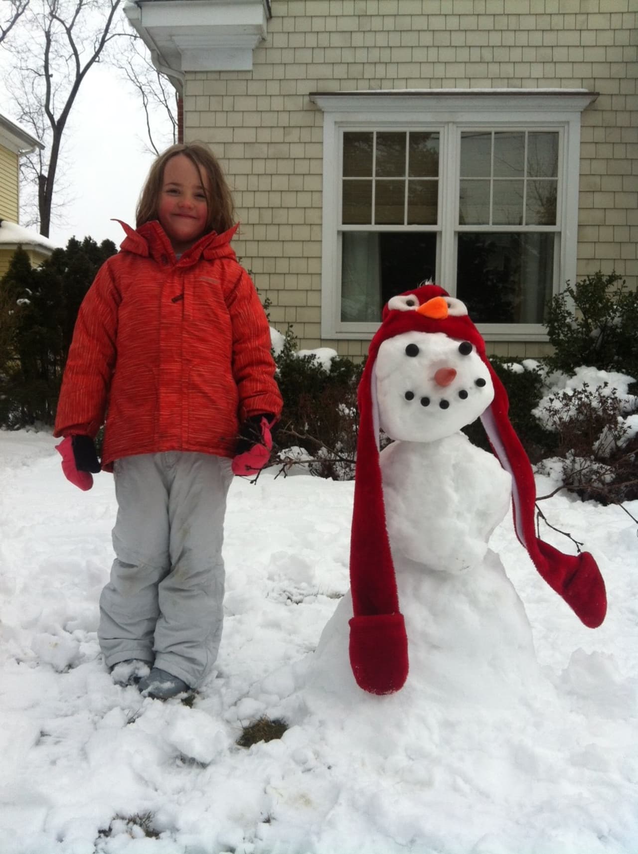 Charlotte Laurence, 6, of New Canaan stands next to the snowman she made Friday. 