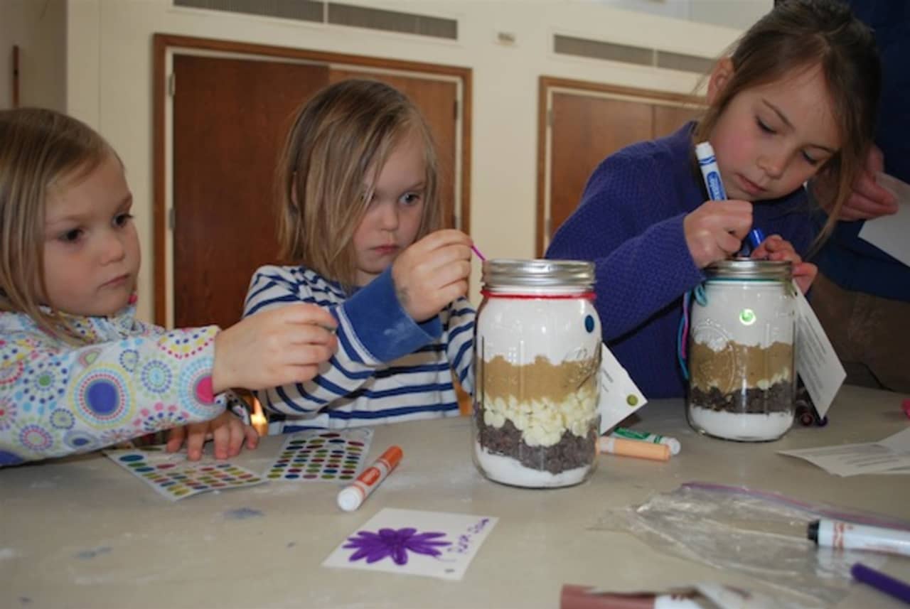 From left, Keeley Strine and Grayson Strine, of New Canaan, and Janie Walsh, of Wilton, decorate
Jars of Joy for Family and Childrens Agency as part New Canaan Country Schools Community Service
Day on March 9.