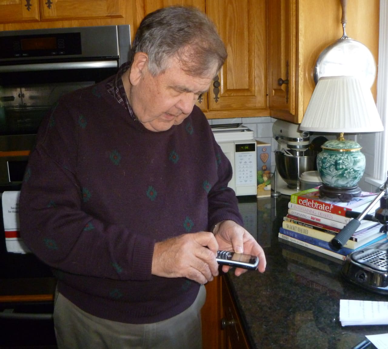 Geoffrey Pickard attempts to make a call in his New Canaan home, which he hopes will be easier with new cell phone towers. 