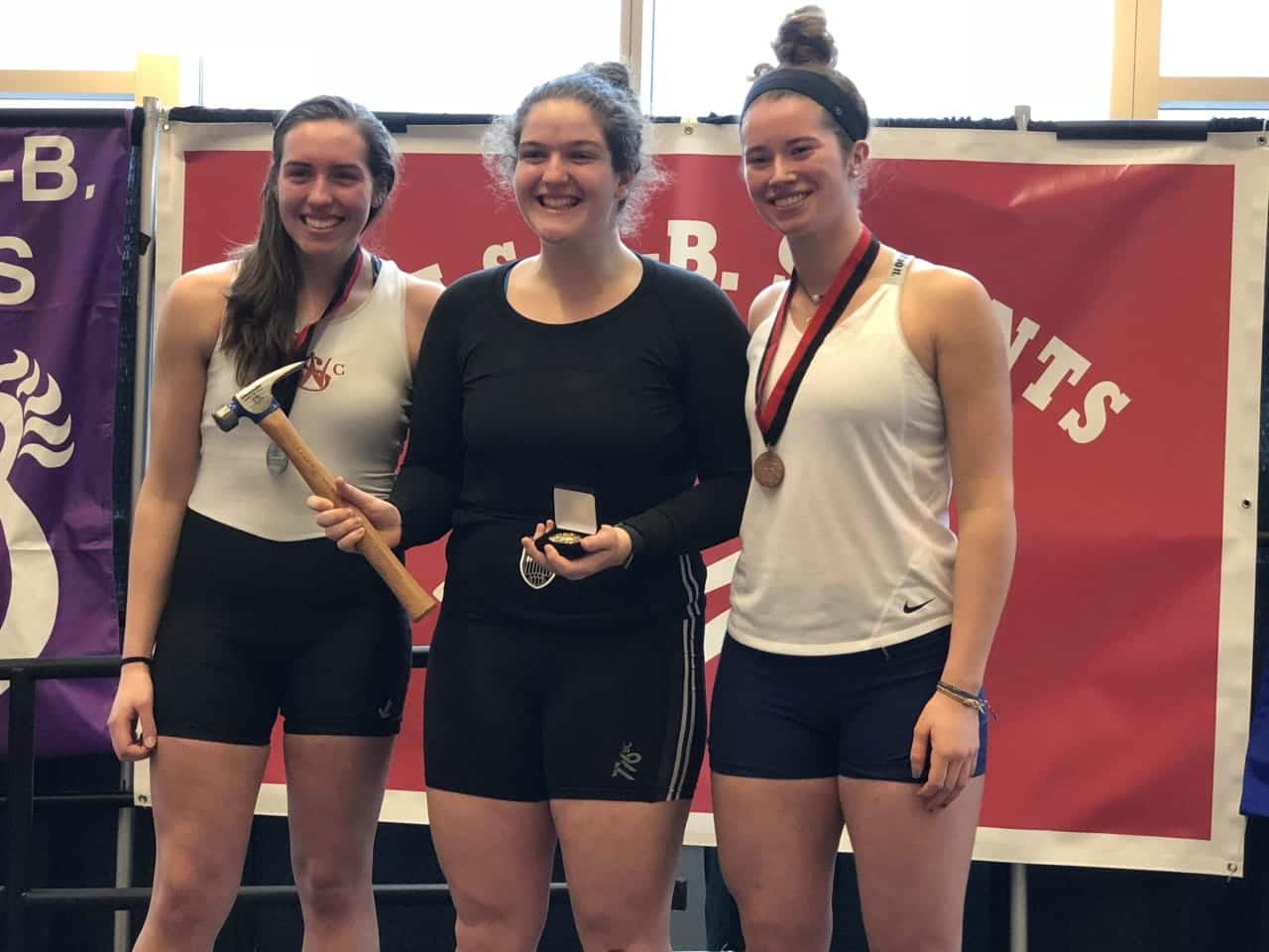 Sydney Kend, center, recently won gold in a prestigious indoor rowing competition.