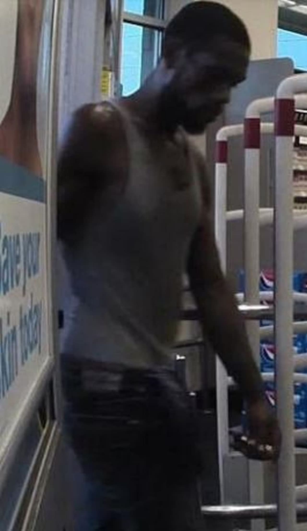 SEEN HIM? Newark police say this man is seen here forcing a carjacking victim to pull cash from an ATM July 7.