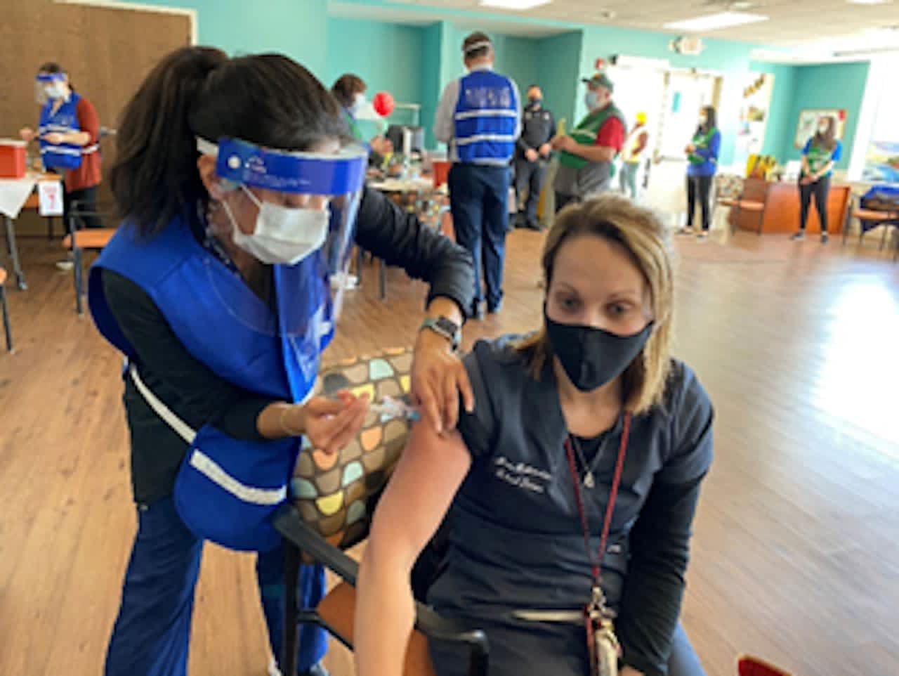 Rebecca Garcia, RN, public health nurse at the Putnam County Department of Health, administers the first dose of COVID-19 vaccine to Jennifer Mottarella, LPN, the school nurse at St. James school in the Carmel Central School District.