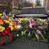 Tow trucks adorned with flowers led a procession for Sal Brescia.