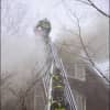 Norwalk firefighters battle a smoky blaze Saturday at 30 West Rocks Road. One man died in the fire.