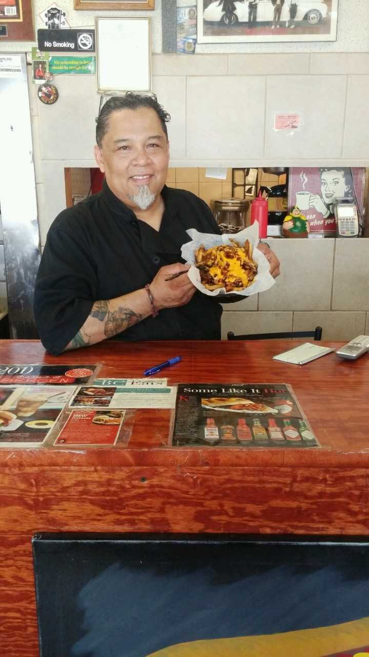 Rony Alvarado, owner of Bergenfield's Rony's Rockin' Grill, shows off the Disco Sucks fries.