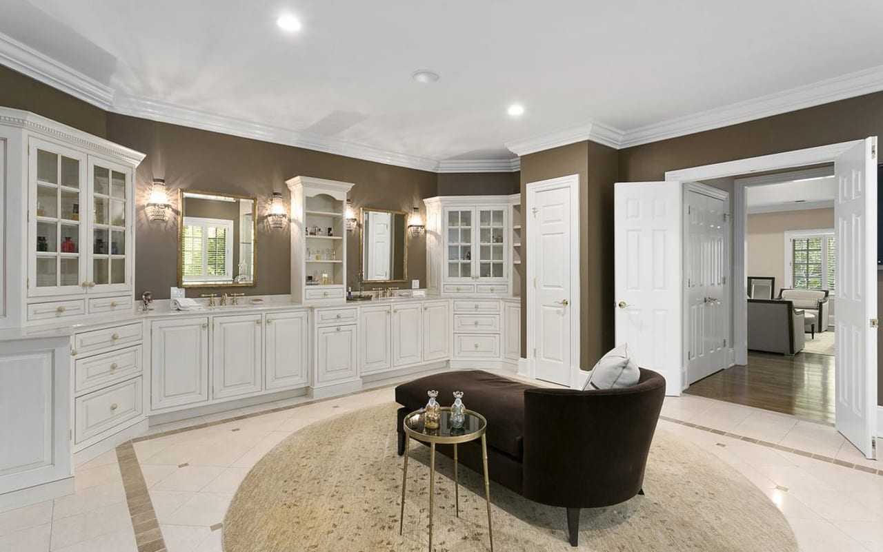 The home's master bathroom is complete with dual shower, sitting area and a fireplace.