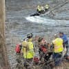 First responders work to save a man stranded in the river.
