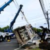 Heavy-Duty Wreckers Remove Tipped Garbage Truck From Jammed Route 17